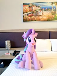 Size: 768x1024 | Tagged: safe, artist:nekokevin, character:starlight glimmer, species:pony, species:unicorn, series:nekokevin's glimmy, bed, cute, female, irl, open mouth, photo, pillow, plushie, sitting, smiling, solo, telephone, underhoof