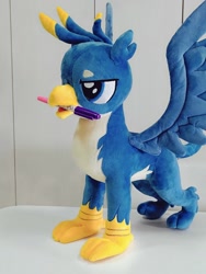 Size: 768x1024 | Tagged: safe, artist:nekokevin, character:gallus, species:griffon, irl, lidded eyes, male, marker, mouth hold, open mouth, photo, plushie, smiling, solo, spread wings, talons, teenager, wings