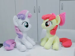 Size: 1024x768 | Tagged: safe, artist:nekokevin, character:apple bloom, character:sweetie belle, species:earth pony, species:pony, species:unicorn, bow, duo, female, filly, hair bow, irl, looking at each other, photo, plushie, sitting, smiling