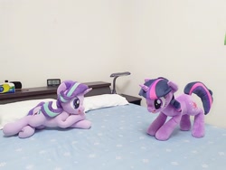 Size: 2048x1536 | Tagged: safe, artist:nekokevin, character:starlight glimmer, character:twilight sparkle, character:twilight sparkle (unicorn), species:pony, species:unicorn, series:nekokevin's glimmy, alarm clock, bed, clock, crossed hooves, duo, female, irl, lying down, mare, open mouth, photo, pillow, plushie, ponies in real life, smiling, underhoof