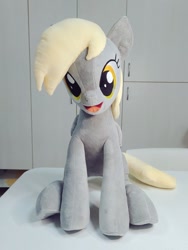 Size: 768x1024 | Tagged: safe, artist:nekokevin, character:derpy hooves, species:pegasus, species:pony, g4, female, irl, looking at you, mare, open mouth, photo, plushie, sitting, smiling, solo, underhoof