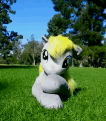 Size: 700x800 | Tagged: safe, artist:agatrix, artist:earthenhoof, character:derpy hooves, species:pegasus, species:pony, animated, female, grass, irl, mare, no sound, park, photo, plushie, solo, webm, wind