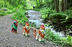 Size: 1953x1286 | Tagged: safe, artist:hihin1993, character:autumn blaze, character:cinder glow, character:summer flare, species:kirin, background kirin, female, follow the leader, forest, irl, japan, path, photo, plushie, river, stream