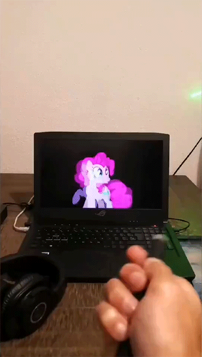 Size: 408x720 | Tagged: safe, artist:stormxf3, character:pinkie pie, species:earth pony, species:human, species:pony, animated, behaving like a cat, computer, cute, diapinkes, female, flashlight (object), fourth wall, gif, hand, headphones, irl, irl human, laptop computer, laser pointer, mare, offscreen character, offscreen human, photo, ponies in real life, twitter link