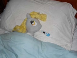 Size: 600x450 | Tagged: safe, artist:eratosofcyrene, character:derpy hooves, species:pegasus, species:pony, bed, ear thermometer, female, irl, mare, photo, pillow, plushie, sick, solo