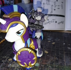 Size: 2160x2114 | Tagged: safe, artist:omegapony16, character:shining armor, species:human, species:pony, guardians of harmony, gun, helmet, irl, male, misadventures of the guardians, photo, riding, shield, soldier, stallion, toy, weapon