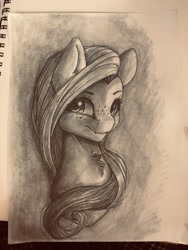 Size: 3024x4032 | Tagged: safe, artist:miokomata, character:fluttershy, species:pegasus, species:pony, bust, chest fluff, fangs, female, freckles, freckleshy, grayscale, irl, looking at you, mare, monochrome, photo, sketch, sketchbook, traditional art