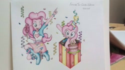 Size: 1536x864 | Tagged: safe, artist:fernandojc-draftsman, character:pinkie pie, species:earth pony, species:pony, g4, my little pony:equestria girls, box, cake, clothing, confetti, duo, female, food, human ponidox, mare, one eye closed, party horn, ponidox, pony in a box, present, self ponidox, signature, sitting, smiling, traditional art, wink