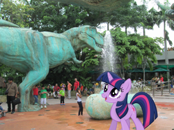 Size: 4608x3456 | Tagged: safe, artist:missbeigepony, artist:vaderpl, character:twilight sparkle, species:human, dinosaur, egg, irl, jurassic park, park, photo, ponies in real life, singapore, solo, statue, tree, tyrannosaurus rex, universal studios, vector, water fountain