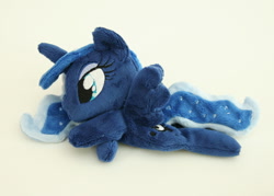 Size: 1000x716 | Tagged: safe, artist:yukamina-plushies, character:princess luna, species:alicorn, species:pony, beanie (plushie), female, horn, irl, mare, missing accessory, photo, plushie, prone, solo, spread wings, wings