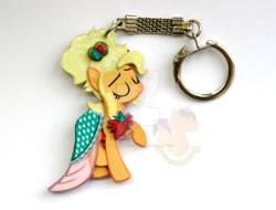 Size: 1024x778 | Tagged: safe, artist:king-franchesco, character:applejack, species:earth pony, species:pony, episode:simple ways, g4, my little pony: friendship is magic, clothing, commission, dress, eyes closed, female, hooves, irl, keychain, mare, photo, raised hoof, smiling, solo