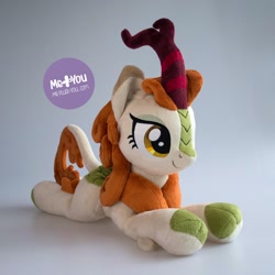 Size: 1600x1600 | Tagged: safe, alternate version, artist:meplushyou, character:autumn blaze, species:kirin, episode:sounds of silence, g4, my little pony: friendship is magic, cloven hooves, female, irl, photo, plushie, prone, smiling, solo, watermark