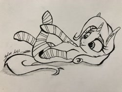 Size: 4032x3024 | Tagged: safe, artist:galinn-arts, character:trixie, species:pony, species:unicorn, clothing, cute, female, lying down, mare, monochrome, on back, smiling, socks, solo, striped socks, traditional art