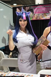 Size: 800x1200 | Tagged: safe, artist:ridd1e, artist:yayacosplay, character:twilight sparkle, species:human, book, clothing, comikaze expo, convention, cosplay, irl, irl human, photo, skirt, solo, stall, tube skirt