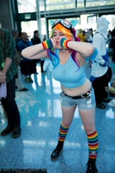 Size: 1365x2048 | Tagged: safe, artist:geekeryandsuch, character:rainbow dash, species:human, anime expo, belly button, clothing, convention, cosplay, goggles, irl, irl human, midriff, photo, rainbow socks, socks, striped socks, wristband