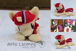 Size: 2382x1588 | Tagged: safe, artist:plushbyanto, character:moondancer, species:pony, species:unicorn, episode:amending fences, episode:the point of no return, g4, my little pony: friendship is magic, beanie (plushie), big eyebrows, chibi, clothing, cropped, eyes closed, female, front view, glasses, hairclip, happy, horn, irl, lying down, mare, messy mane, messy tail, minky, missing accessory, no mouth, no nostrils, no pupils, photo, plushie, profile, prone, smiling, solo, sploot, sweater, toy