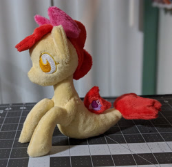 Size: 2148x2083 | Tagged: safe, artist:plushbyanto, character:apple bloom, species:seapony (g4), beanie (plushie), bow, chibi, female, filly, fins, irl, lying down, no mouth, no nostrils, no pupils, photo, plushie, profile, race swap, seaponified, seapony apple bloom, solo, species swap, tail fin, toy