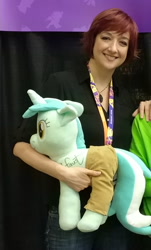 Size: 1100x1820 | Tagged: safe, artist:hoppip, character:lyra heartstrings, species:human, species:pony, species:unicorn, 2019, autograph, betrayal, blessed image, bronycon, bronycon 2019, clothing, cropped, cursed image, everything is ruined, female, irl, irl human, lauren faust, lyra plushie, mare, not salmon, pants, photo, plothole plush lyra, plushie, signature, we are going to hell