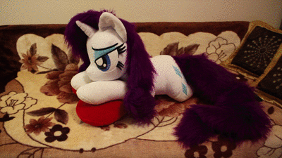 Size: 400x225 | Tagged: safe, artist:ponimalion, character:rainbow dash, character:rarity, animated, bed, bedroom eyes, duo, duo female, female, heart, heart pillow, irl, jumping, life size, photo, pillow, plushie, youtube, youtube link