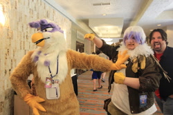 Size: 1280x853 | Tagged: safe, artist:neouka, artist:spainfischer, character:gilda, species:griffon, species:human, clothing, cosplay, cosplay vs furry, fursuit, irl, irl human, larson you magnificent bastard, m.a. larson, photo, photobomb, sydneyroo(coser)