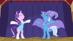 Size: 1920x1080 | Tagged: safe, artist:phucknuckl, character:starlight glimmer, character:trixie, species:pony, species:unicorn, assistant, bipedal, bow tie, cape, clothing, cutie mark, eyes closed, hat, hoof gloves, leotard, open mouth, outstretched arms, rearing, requested art, smiling, stage, trixie's cape, trixie's hat, underhoof, wizard hat