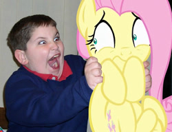Size: 600x460 | Tagged: safe, artist:dtkraus, character:fluttershy, species:human, species:pony, child, creepy, holding a pony, irl, irl human, photo, ponies in real life, red eye, scared, target demographic, terror, wat