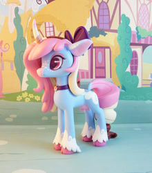 Size: 749x850 | Tagged: safe, artist:krowzivitch, oc, oc only, oc:polly, species:cow, species:pony, species:unicorn, bow, choker, cloven hooves, cow pony, craft, curved horn, female, figurine, hair bow, heart eyes, horn, mare, sculpture, solo, traditional art, udder, unshorn fetlocks, wingding eyes