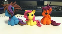 Size: 4093x2259 | Tagged: safe, artist:dawn-designs-art, character:fluttershy, character:scootaloo, oc, oc:dawn, species:pegasus, species:pony, blue coat, brown mane, craft, female, filly, group, jewelry, mare, necklace, orange coat, pink mane, purple mane, sculpey, sculpt, sculpted, sculpture, yellow coat