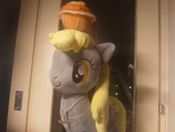 Size: 500x375 | Tagged: safe, artist:onlyfactory, character:derpy hooves, species:pegasus, species:pony, bootleg, female, irl, mare, muffin, necklace, photo, plushie, toy, waifu, window