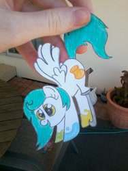 Size: 720x960 | Tagged: safe, artist:partylikeanartist, oc, oc only, oc:chroma feather, species:pegasus, species:pony, amputee, hand, hanging, paper child, paper pony, papercraft, photo, prosthetic limb, solo, traditional art