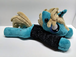 Size: 600x449 | Tagged: safe, artist:catnapcaps, species:pony, species:unicorn, as it is, beanie (plushie), clothing, commission, ear piercing, gauges, hair over one eye, horn, horn piercing, irl, male, nose piercing, patty walters, photo, piercing, plushie, ponified, prone, shirt, solo, stallion