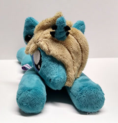 Size: 400x417 | Tagged: safe, artist:catnapcaps, species:pony, species:unicorn, as it is, beanie (plushie), commission, ear piercing, gauges, hair over one eye, horn, horn piercing, irl, male, nose piercings, patty walters, photo, piercing, plushie, ponified, prone, solo, stallion
