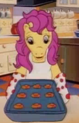 Size: 228x355 | Tagged: safe, screencap, character:bon bon (g1), species:pony, g1, my little pony tales, cropped, kitchen, oven mitts, solo