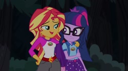 Size: 1100x618 | Tagged: safe, screencap, character:sunset shimmer, character:twilight sparkle, character:twilight sparkle (scitwi), species:eqg human, equestria girls:legend of everfree, g4, my little pony:equestria girls, backpack, camp everfree outfits, clothing, glasses, shorts, sun, tree