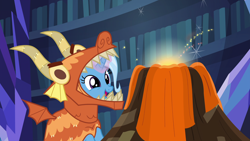 Size: 1920x1080 | Tagged: safe, screencap, character:trixie, species:pony, species:unicorn, episode:uncommon bond, g4, my little pony: friendship is magic, board game, clothing, costume, cute, diatrixes, dragon costume, dragon pit, female, glowing horn, mare, open mouth, smiling, solo