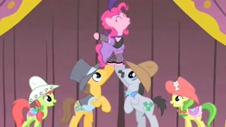 Size: 1280x720 | Tagged: safe, screencap, character:apple fritter, character:caramel, character:lucky clover, character:peachy sweet, character:pinkie pie, episode:over a barrel, g4, my little pony: friendship is magic, apple family member, clothing, costume, eyes closed, lifting, saloon pinkie, singing, stage, you gotta share