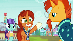 Size: 1280x720 | Tagged: safe, screencap, character:mixed berry, character:stellar flare, character:sunburst, species:earth pony, species:pony, species:unicorn, episode:the parent map, g4, background pony, clothing, cup, female, glasses, grin, jewelry, male, mare, mother and son, necklace, raised hoof, robe, sire's hollow, smiling, stallion, sunburst is not amused, unamused