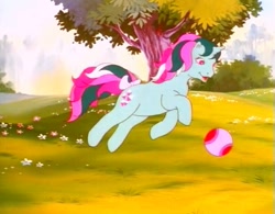 Size: 737x574 | Tagged: safe, screencap, character:fizzy, species:pony, species:twinkle eyed pony, species:unicorn, g1, my little pony: the movie (1986), ball, cute, female, flower, jumping, smiling, solo, tree