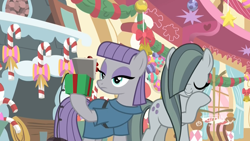 Size: 1920x1080 | Tagged: safe, screencap, character:marble pie, character:maud pie, species:earth pony, species:pony, episode:best gift ever, g4, my little pony: friendship is magic, bell, bow, box, candy, candy cane, decoration, duo, female, fireplace, food, hearth's warming, hearth's warming ornament, hoof over mouth, laughing, mare, maud being maud, pinkie pie's room, present, rock-in-the-box, sisters, sugarcube corner