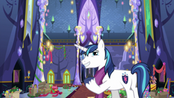 Size: 1280x720 | Tagged: safe, screencap, character:shining armor, species:pony, species:unicorn, episode:best gift ever, g4, my little pony: friendship is magic, candy, candy cane, christmas, christmas lights, christmas wreath, clothing, food, holiday, male, plot, raised hoof, scarf, solo, stallion, twilight's castle, wreath