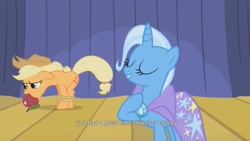 Size: 1600x900 | Tagged: safe, screencap, character:applejack, character:trixie, species:earth pony, species:pony, species:unicorn, episode:boast busters, g4, my little pony: friendship is magic, duo, duo female, female, mare, stage, tied up, youtube caption