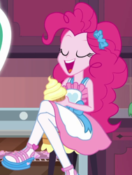 Size: 480x636 | Tagged: safe, screencap, character:pinkie pie, episode:the craft of cookies, g4, my little pony:equestria girls, apron, clothing, cropped, crossed legs, cupcake, cute, diapinkes, food, frosting, kitchen, legs, open mouth