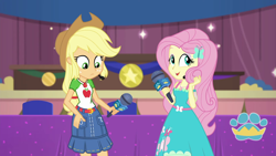Size: 1920x1080 | Tagged: safe, screencap, character:applejack, character:fluttershy, episode:best in show: the victory lap, g4, my little pony:equestria girls, geode of fauna, geode of super strength, magical geodes, microphone, playing with hair