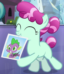 Size: 512x596 | Tagged: safe, screencap, character:cherry valley, character:spike, species:crystal pony, species:earth pony, species:pony, episode:the crystalling, g4, my little pony: friendship is magic, blank flank, cropped, eyes closed, female, filly, mouth hold, photo, rock candy (character), solo