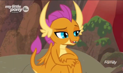 Size: 1278x758 | Tagged: safe, screencap, character:smolder, species:dragon, episode:sweet and smoky, g4, my little pony: friendship is magic, claws, discovery family logo, dragoness, fangs, female, folded wings, horns, lidded eyes, raised eyebrow, raised tail, sitting, smiling, solo, tail, teenager, wings, young