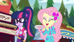 Size: 1600x900 | Tagged: safe, screencap, character:fluttershy, character:twilight sparkle, character:twilight sparkle (scitwi), species:eqg human, episode:lost and pound, g4, my little pony:equestria girls, clothing, cute, flower, flower in hair, food truck, geode of fauna, geode of telekinesis, glasses, magical geodes, ponytail, shyabetes, yay
