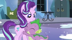 Size: 1280x720 | Tagged: safe, screencap, character:spike, character:starlight glimmer, species:dragon, species:pony, species:unicorn, episode:the crystalling, g4, my little pony: friendship is magic, adorable face, cute, cute smile, dawwww, eyes closed, female, hug, mare, shipping fuel, smiling, snow, spikelove, table