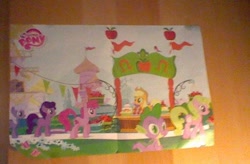 Size: 616x404 | Tagged: safe, screencap, character:applejack, character:berry punch, character:berryshine, character:spike, species:dragon, species:earth pony, species:pony, episode:the ticket master, g4, my little pony: friendship is magic, season 1, 2010, 2011, apple, background pony, camera, canterlot, chilly puddle, collection, dusky grape, female, flag, flower, food, magazine, mare, my little pony, nintendo ds, photo, poster, stand