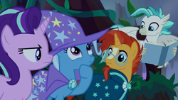 Size: 1920x1080 | Tagged: safe, screencap, character:starlight glimmer, character:sunburst, character:terramar, character:trixie, species:classical hippogriff, species:hippogriff, species:pony, episode:student counsel, book, cape, clothing, hat, trixie's cape, trixie's hat