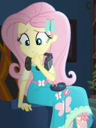 Size: 719x958 | Tagged: safe, screencap, character:fluttershy, episode:costume conundrum, g4, my little pony:equestria girls, controller, couch, cropped, cute, female, gaming headset, headset, headset mic, looking down, sitting, solo, sunset's apartment, thinking